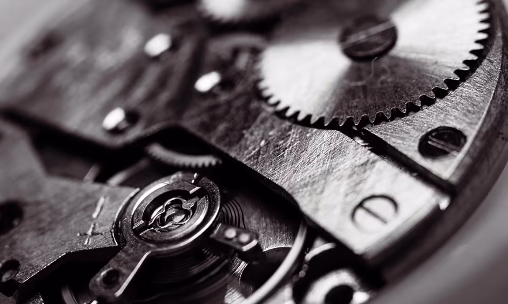 Close-up of watch gears, representing the precision behind custom-made print materials