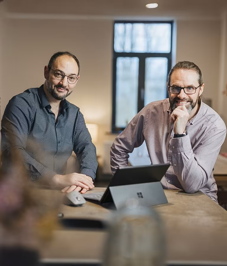 Qreative’s founders posing inside the agency’s digital workspace